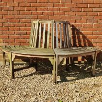 A teak half-round tree bench