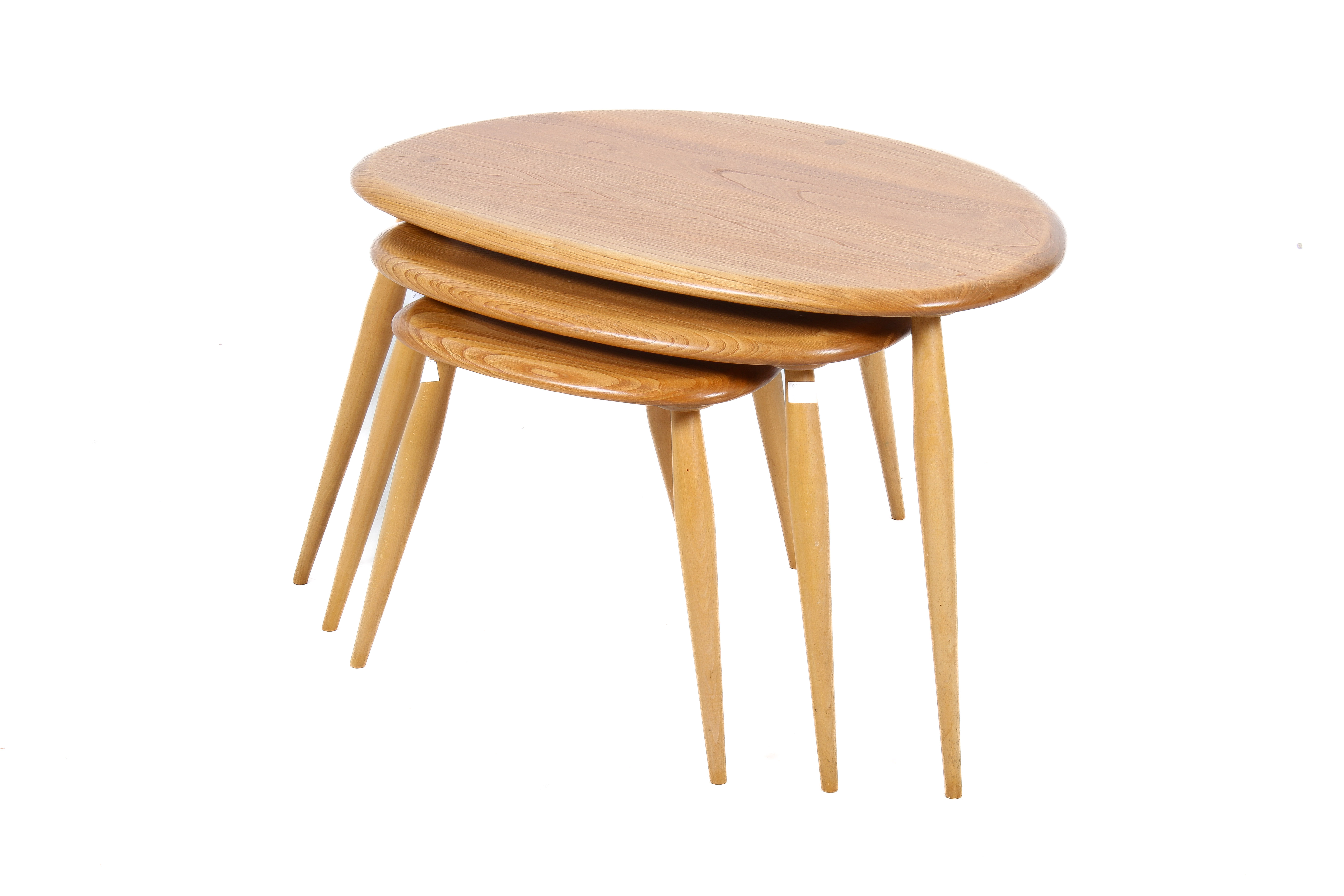 A mid-century Ercol blonde beech and elm nest of tables.