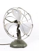 A mid-century H Frost & Co Ltd adjustable three vane electric desk fan. With a green metal base.