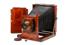 An Ensign antique mahogany and brass half-plate camera.