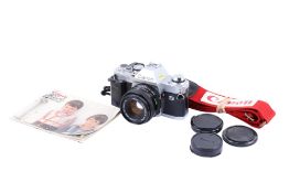 A Canon AL-1 35mm SLR camera. Chrome. Serial number 1115788. With a Canon FD 50mm f1.