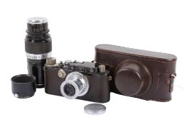 A Leitz Wetzlar Leica III 35mm Rangefinder camera outfit. Black and chrome body. 1934.