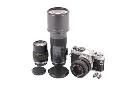 An Olympus OM-2n 35mm SLR camera outfit. With three lenses; an Olympus OM 28-48mm f4 S.