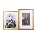 Two framed military portraits.