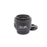 A Nikon AF-S Nikkor 35mm f1.8 G DX lens. With front and rear caps.