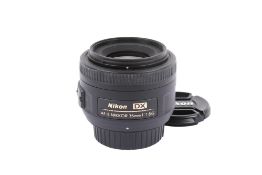 A Nikon AF-S Nikkor 35mm f1.8 G DX lens. With front and rear caps.