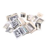 A box of antique and vintage photographs and postcards.
