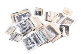 A box of antique and vintage photographs and postcards.