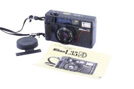 A Nikon L35 AD 35mm Compact camera. With a Nikon 35mm f2.8 lens, lens cap and instruction guide.