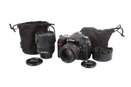 A Nikon D7000 Digital SLR camera outfit. With two lenses; an AF-S Nikkor 50mm f1.