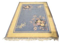 A contemporary wool rug with sprays of floral decoration on a grey ground.