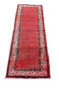 A red ground handmade runner.