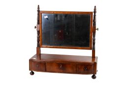 A Victorian mahogany veneer swing mirror. Raised on a base with three drawers and turned feet.