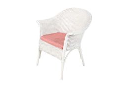 A vintage Lloyd loom style chair with a fabric cushion.