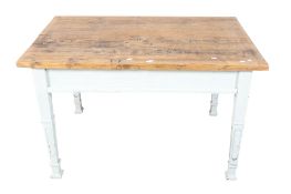 A rustic four plank pine top kitchen table with white painted legs.