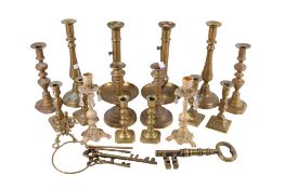 A collection of seven assorted 19th century and later pairs of brass candlesticks and some keys.