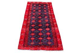 A blue and red wool rug, handmade in Hamadar.