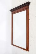 Large mahogany framed overmantle bevelled wall mirror. Having architectural and inlaid decoration.