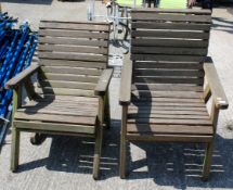 A pair of teak garden chairs.