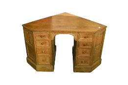An early 20th century limed oak corner desk.