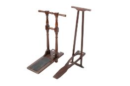 Two vintage wooden boot pullers. One with turned supports and rubber grip, H81cm.