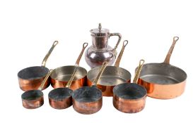 Set of eight assorted French copper saucepans and a plated jug. Max.