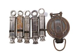Five vintage police whistles and a WWII style compass.