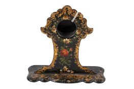 A Victorian papier mache pocket watch holder. Japanned with gilt and floral decoration.