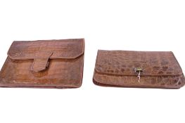 Two vintage pre-loved women's faux crocodile leather clutch handbags.
