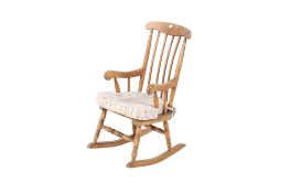 A mid-century child's wooden rocking chair. With detachable seat cushion.