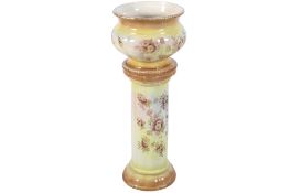 A Victorian jardiniere planter on stand. Transfer decorated with roses with gilt detail.