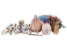 A collector of lace making items, pin cushions and thimbles etc.