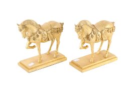 Two gold leaf dancing horse statues. Raised on rectangular stepped plinths. H23cm x W21cm x D10cm.