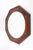 A first half of the 20th century circular wall mirror in a oak frame.