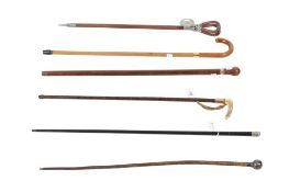 A collection of six assorted walking canes. Including a shooting stick, etc.