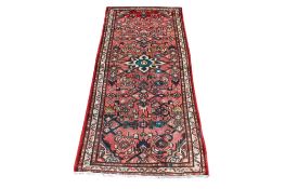 A variegated pink ground handmade wool runner.