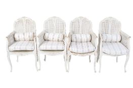 A set of four painted French style bergere armchairs.