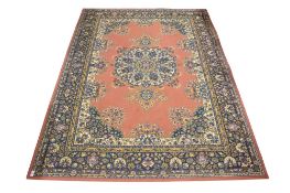 A Persian style wool rug on a red ground.