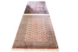 A pair of vintage woollen rugs.