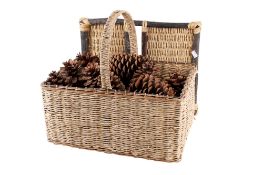 A wicker picnic basket full of large pinecones.