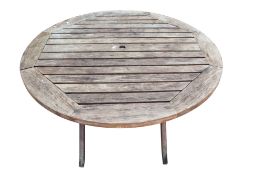 A circular teak garden table.