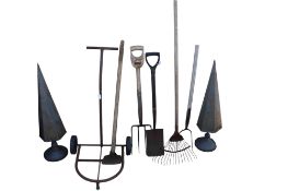 A quantity of assorted vintage garden hand tools and two obelisks painted grey.