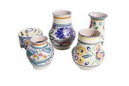 A collection of five assorted mid-century Poole Pottery. Including a flower frog and four vases.