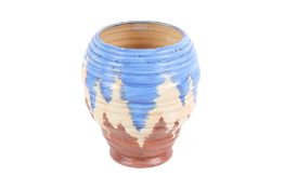 A 1930s Carlton Ware ribbed ceramic vase. With a blue and brown glaze on a cream ground.
