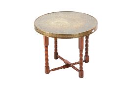 An Anglo Indian brass top folding table. Raised on four bobbins supports united by stretcher.
