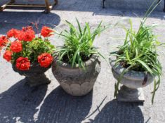A group of three reconstituted stone garden urns. Max.