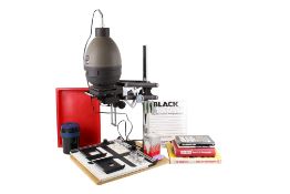A group of vintage photographic darkroom equipment and associated books.