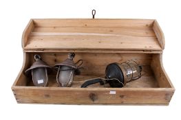 A pine box with three vintage outdoor lamps.
