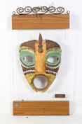 A ceramic African style face mask.