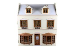 A modern wooden doll's bay window house and contents.
